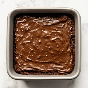 High protein sweet potato brownies baking in the oven until set around the edges.